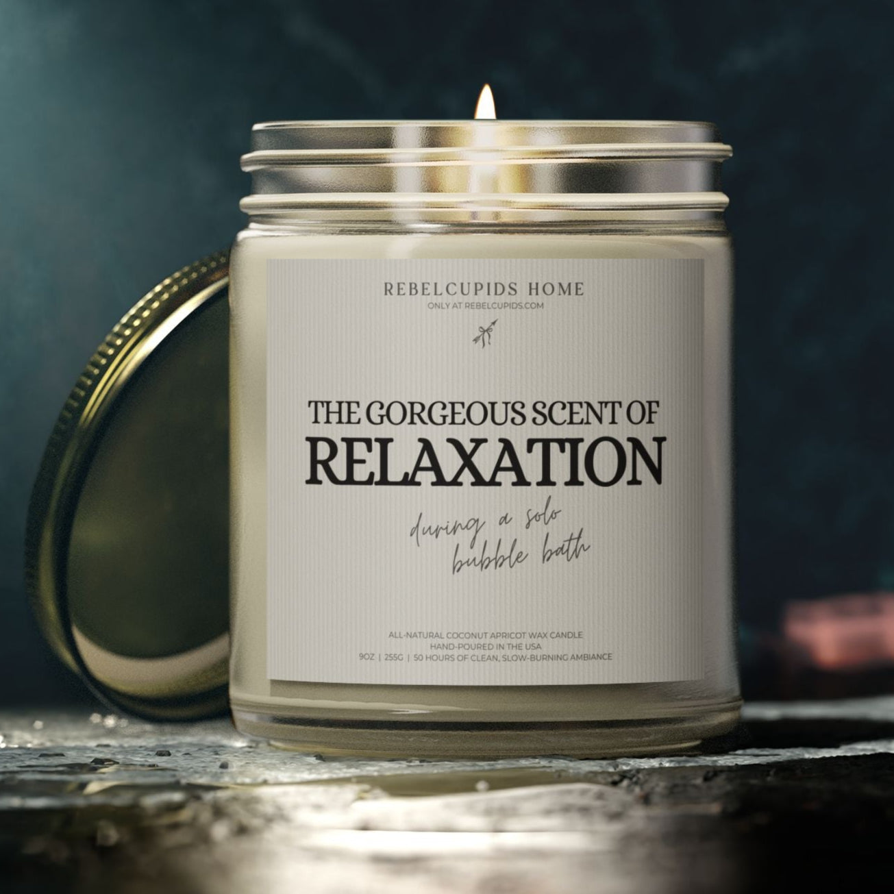 Candle with a label reading 'The Gorgeous Scent of Relaxation' on a dark background