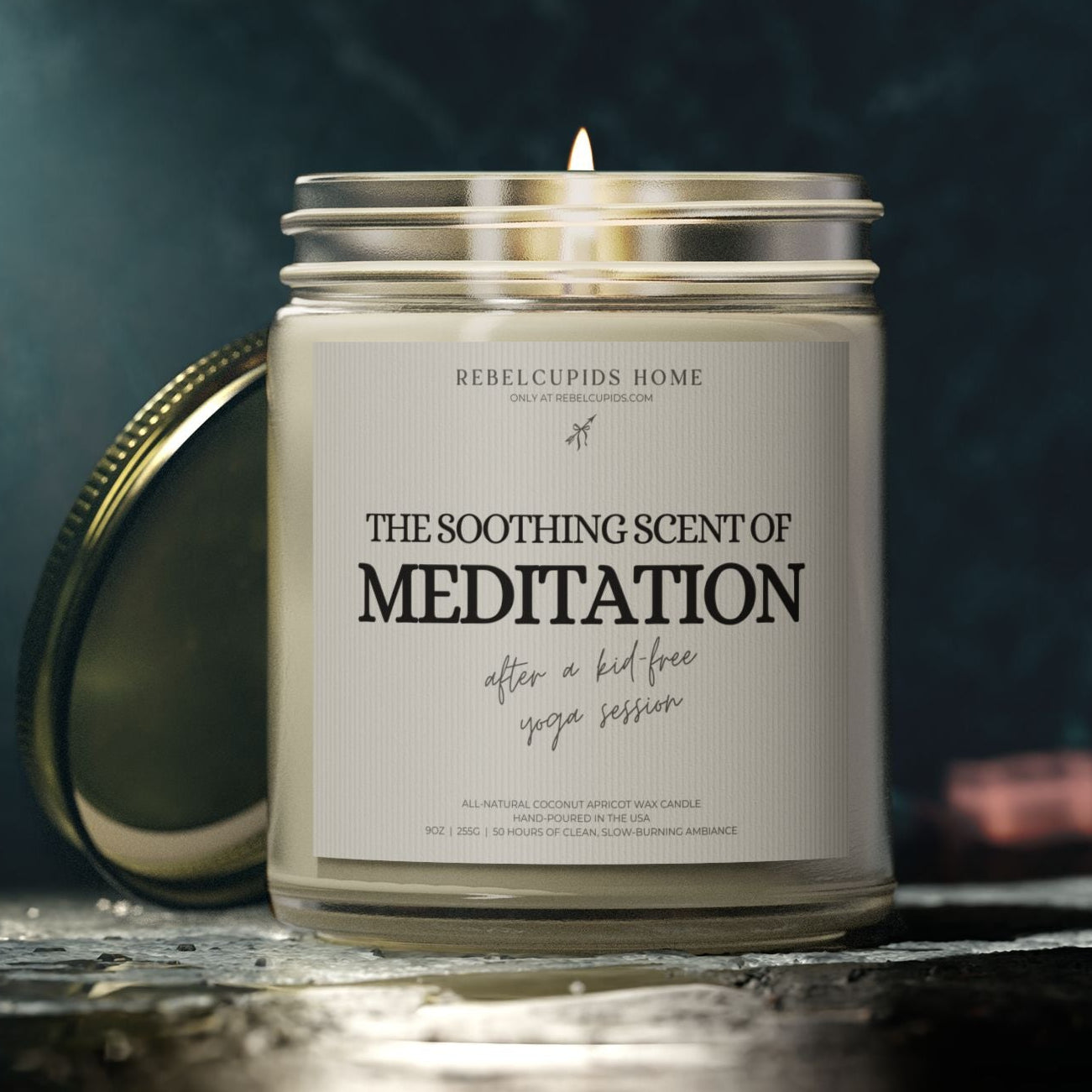Candle in a glass jar with a label reading 'The Soothing Scent of Meditation' by Rebel Cupids Home.