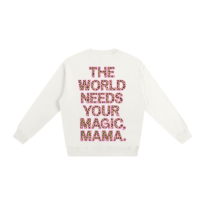 White sweater with pink text 'The World Needs Your Magic, Mama' on a white background