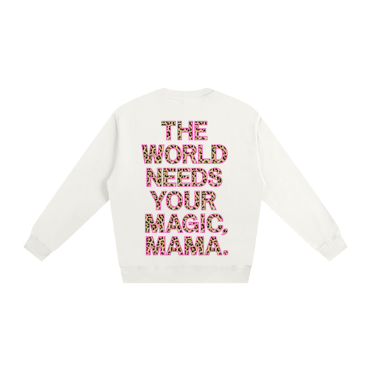 White sweater with pink text 'The World Needs Your Magic, Mama' on a white background